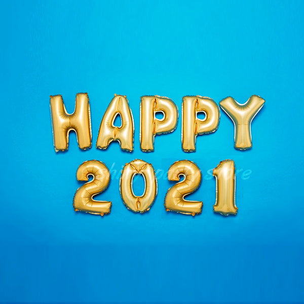 Gold foil letter balloons spelling HAPPY 2021 on a blue background