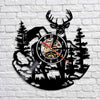 Black silhouette wall clock featuring a woodland elk deer head design and a clock face with a red hand.