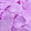 A close-up of purple silk rose petals used for weddings and events.