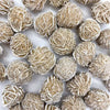 Small, spherical natural desert rose selenite stones with a rough texture.