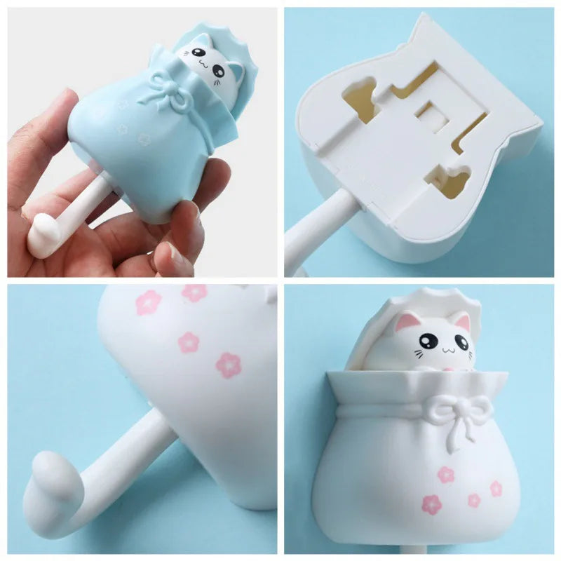 A set of cute cartoon cat wall hooks in light blue and white for organization