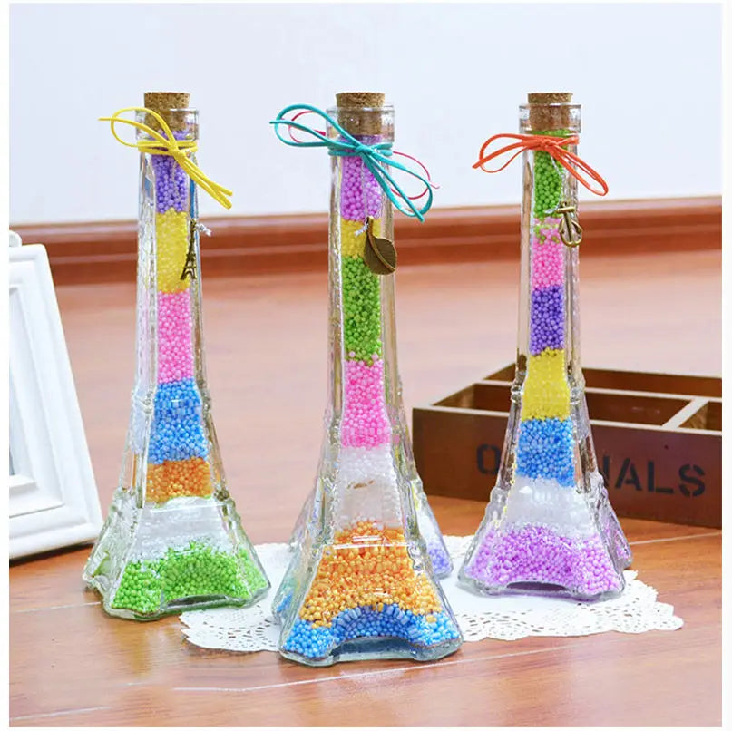 Three glass test tubes filled with colorful pastel foam beads for crafting and decoration