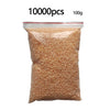 A clear plastic bag filled with 10,000 small, light orange or pinkish beads for craft projects.