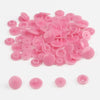 A pile of assorted pink snap buttons, measuring 12mm and 10.5mm, for crafting.