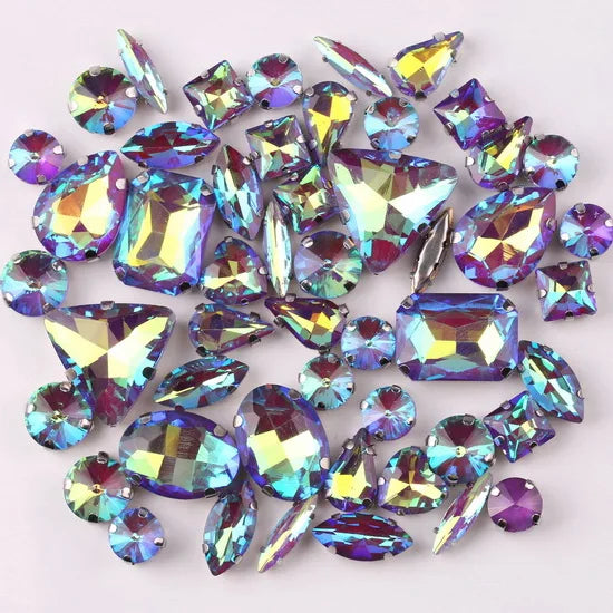 A mix of iridescent glass rhinestones in various colors including purple, blue, and green.
