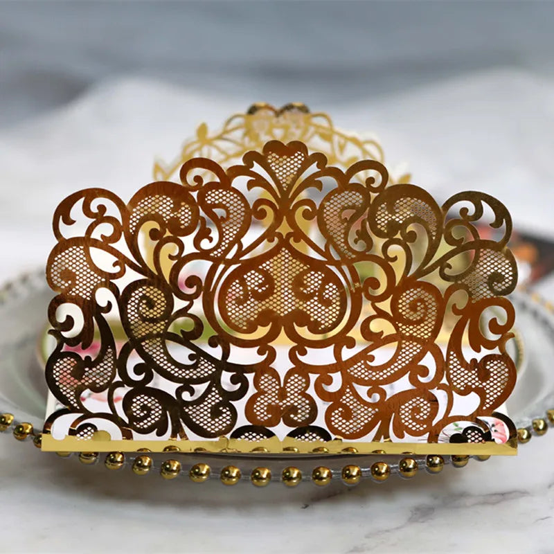 Gold pearl laser cut wedding invitations featuring intricate brown filigree designs