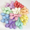 A collection of pastel candy balloons in various shades including pink, purple, yellow, and green.