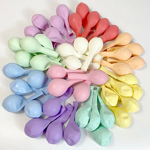 A collection of pastel candy balloons in various shades including pink, purple, yellow, and green.