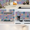 A modern kitchen featuring decorative mandala tile stickers on the backsplash and cabinet fronts.