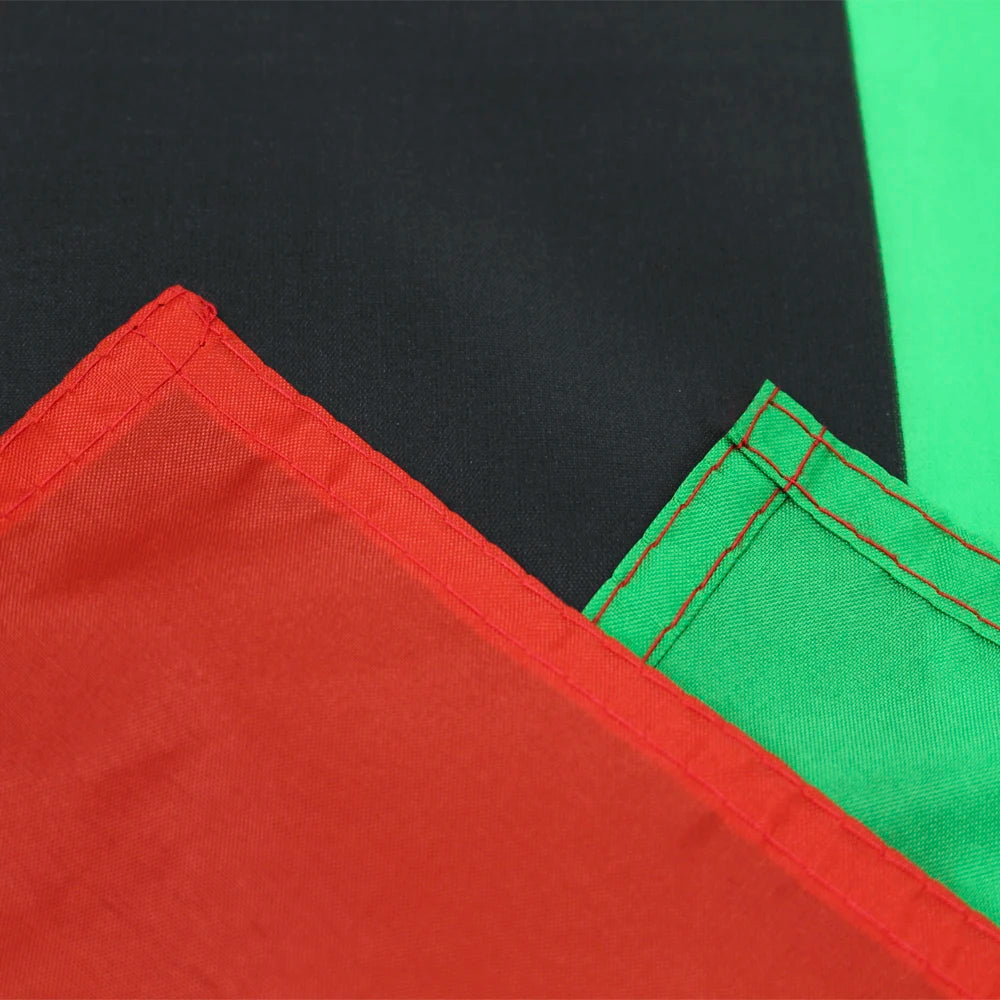 Close-up of a fabric featuring red and green panels, showing stitching details.