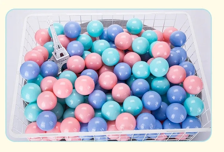 A white basket filled with a 50-pack of colorful, shiny, round balls in shades of pink, blue, and teal.