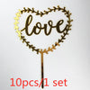 A set of ten gold acrylic heart-shaped love cake toppers with a decorative vine border.