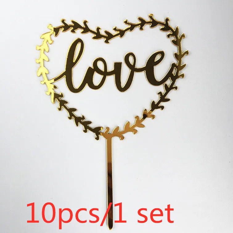 A set of ten gold acrylic heart-shaped love cake toppers with a decorative vine border.