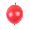 A bright red latex balloon with a thin stem against a white background.