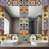 A bathroom vanity featuring a white vessel sink and a large mirror decorated with colorful Moroccan tile patterns.