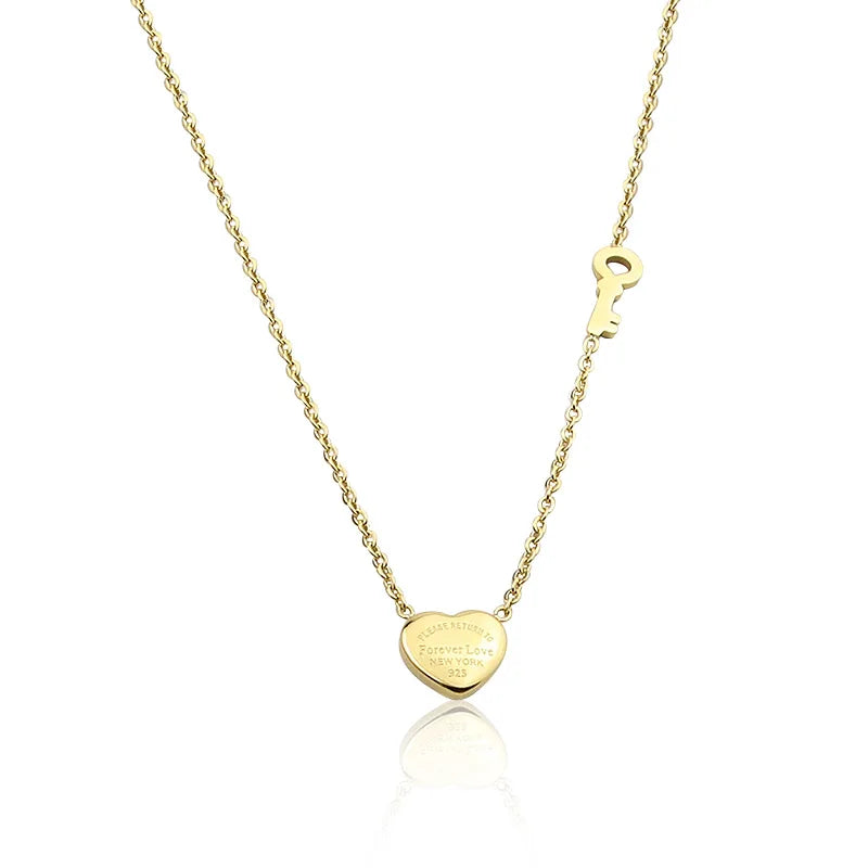 A gold-toned heart lock key pendant necklace with a delicate chain.