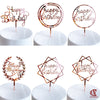 Rose gold acrylic happy birthday cake toppers in various designs on white cake boards