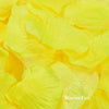 A close-up of bright yellow silk rose petals used for weddings and events.