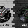 A wall clock featuring a sports car design, shown in two versions: without LED and with LED.