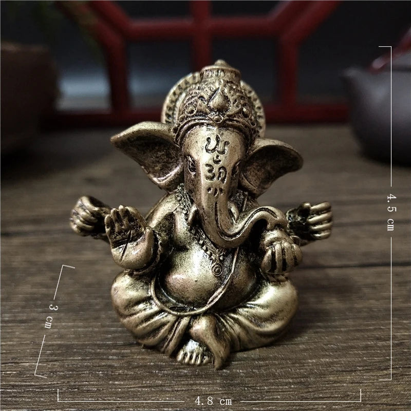 Handcrafted bronze statue of Ganesha with multiple arms sitting in a meditative pose