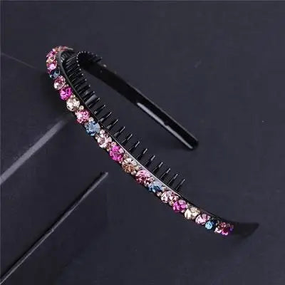 A black headband decorated with colorful crystal and rhinestone embellishments.