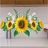 A floral arrangement of yellow sunflowers and white flowers displayed on a white shelf.