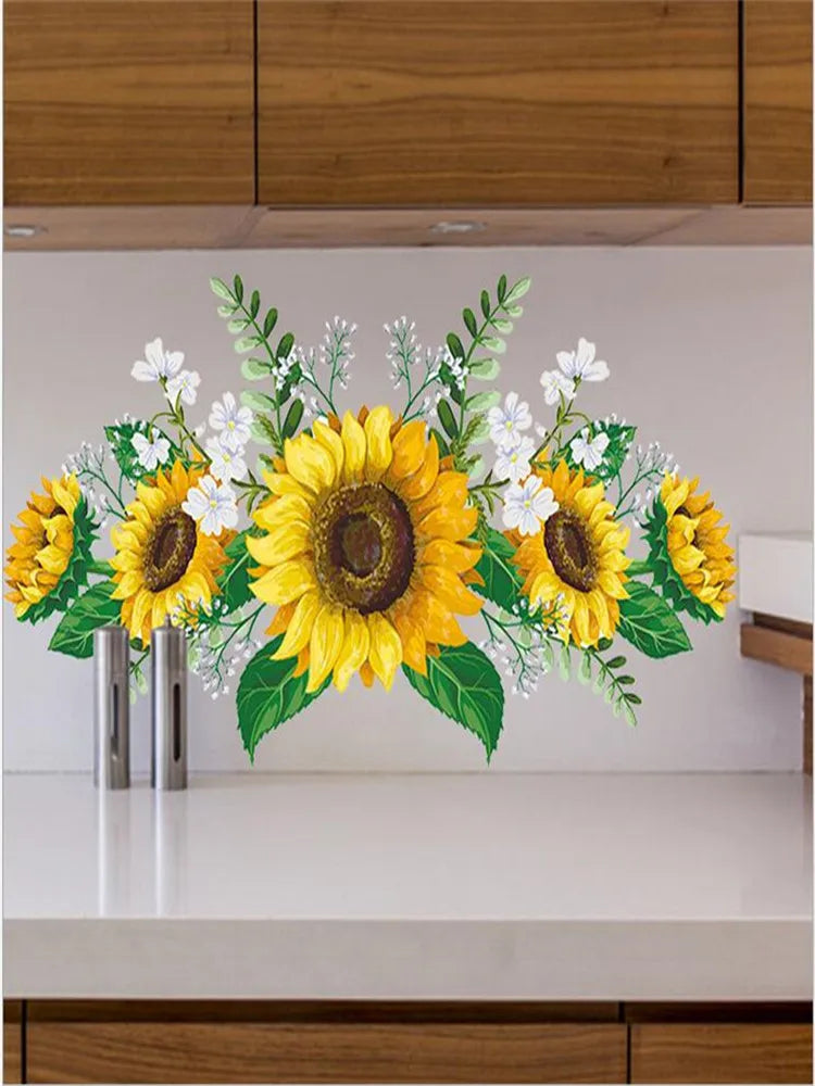 A floral arrangement of yellow sunflowers and white flowers displayed on a white shelf.