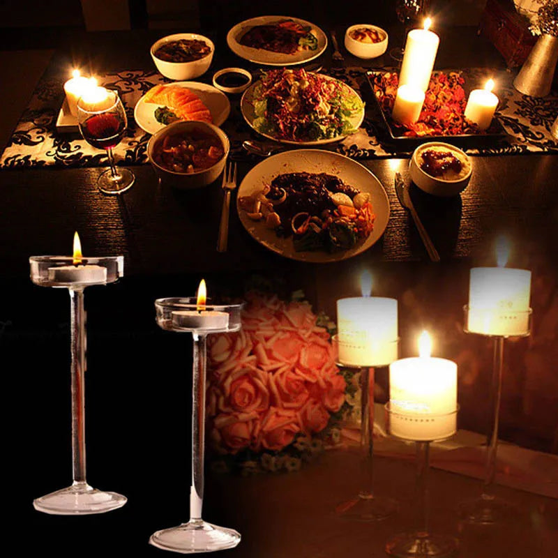 A dark table setting features various food dishes and elegant glass candle holders.