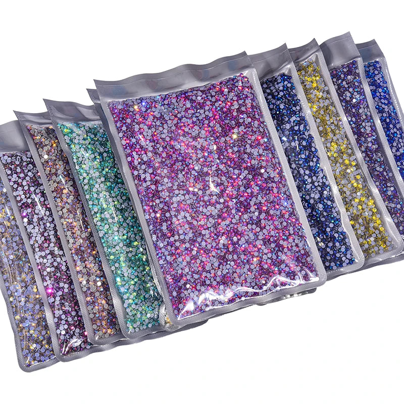 A collection of clear pouches filled with various colors and sizes of hotfix glass rhinestones.