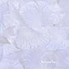 White silk rose petals for weddings and events arranged in a pile.