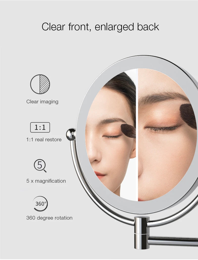 A wall-mounted LED makeup mirror showing clear front and enlarged back with 1:1 real restore and 360 degree rotation features