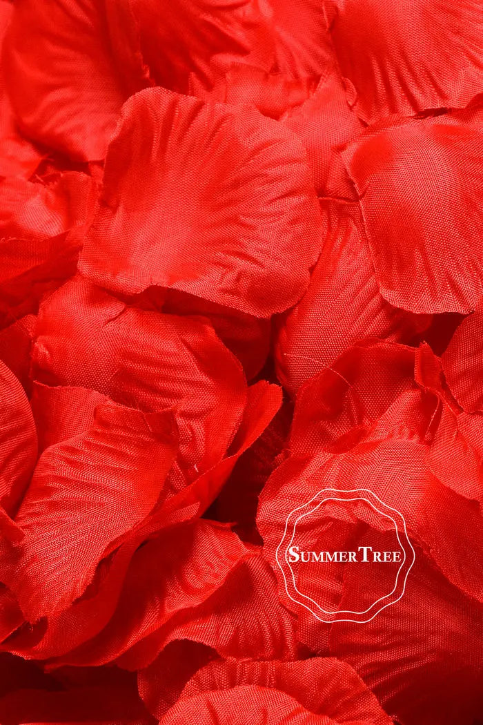 A close-up of vibrant red silk rose petals used for weddings and events.