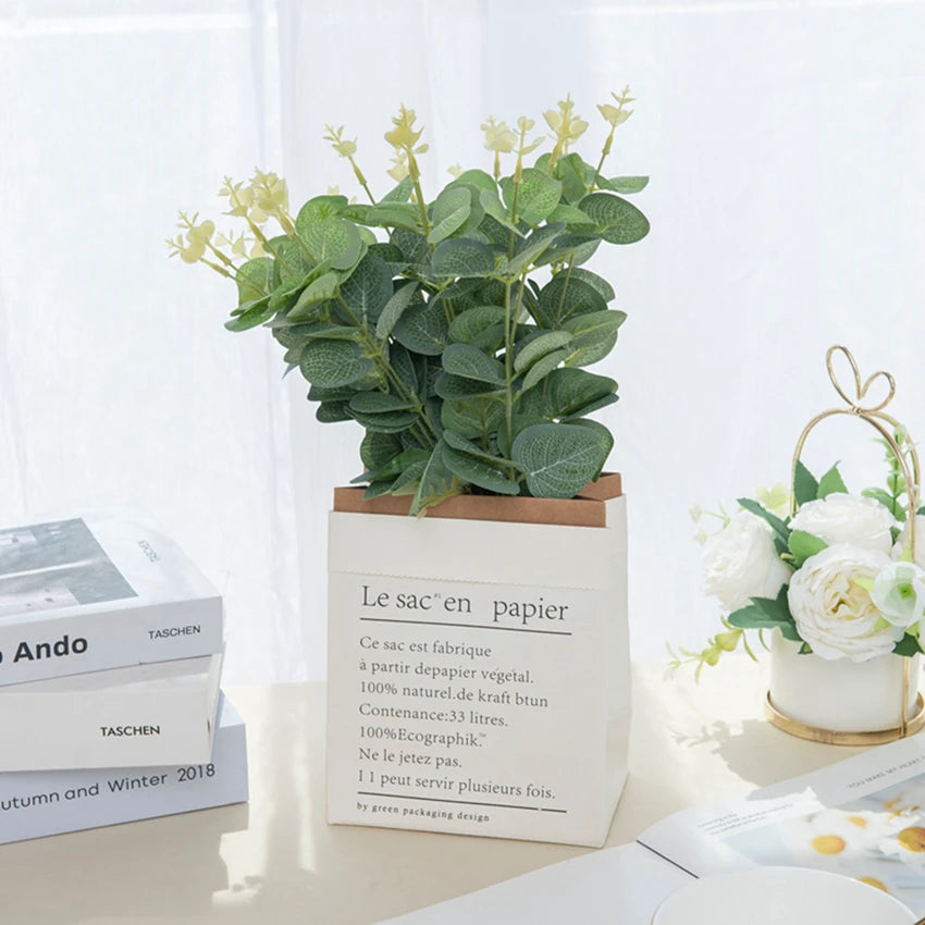 Green eucalyptus leaf stems in a cardboard holder for home and event decor