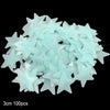 A pile of light blue glow-in-the-dark star and moon wall stickers.