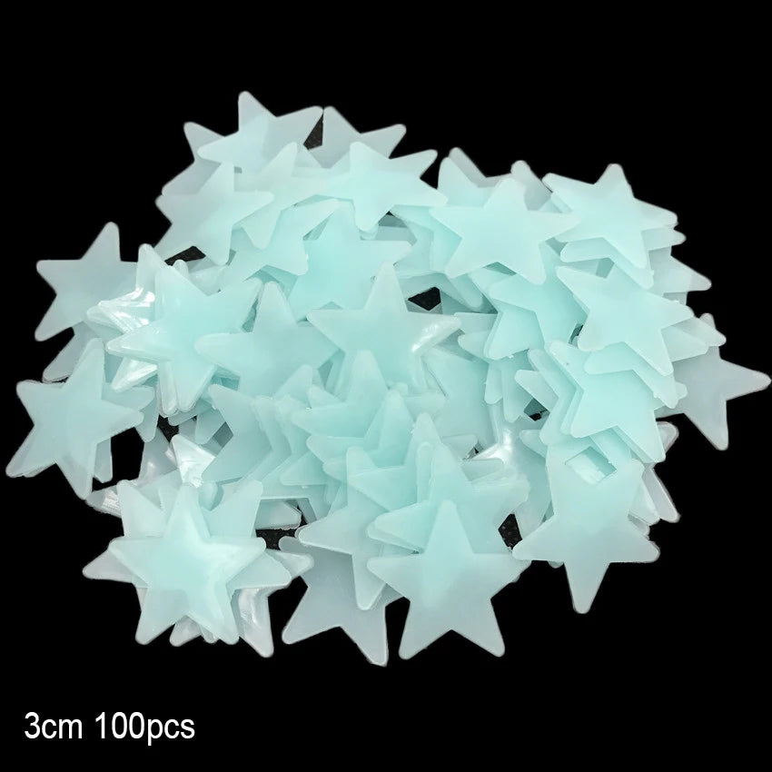 A pile of light blue glow-in-the-dark star and moon wall stickers.