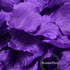 A close-up of vibrant purple silk rose petals used for weddings and events.