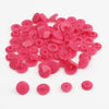 A pile of assorted pink snap buttons, measuring 12mm and 10.5mm, for crafting.
