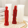 A red silicone mold shaped like a realistic human figure used for candle and resin crafting.