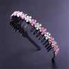 A black headband decorated with pink and clear crystal rhinestones.