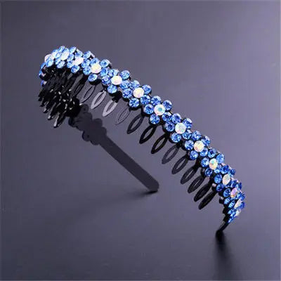 A sparkling blue crystal rhinestone headband with black metal detailing is shown against a dark background.