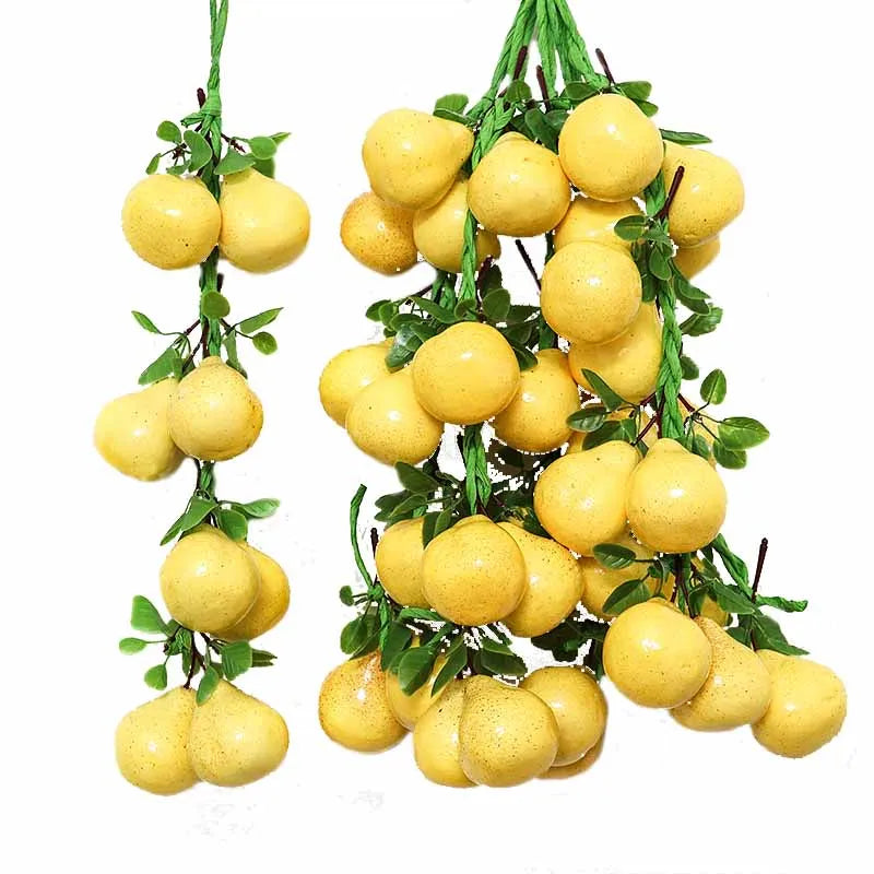 A cluster of yellow artificial fruits and vegetables used for decoration or photography.