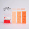 Light orange candle dye colorants in various shades displayed next to a glass container.