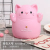 A pink cartoon cat piggy bank with smiling features resting on a gray checkered surface.