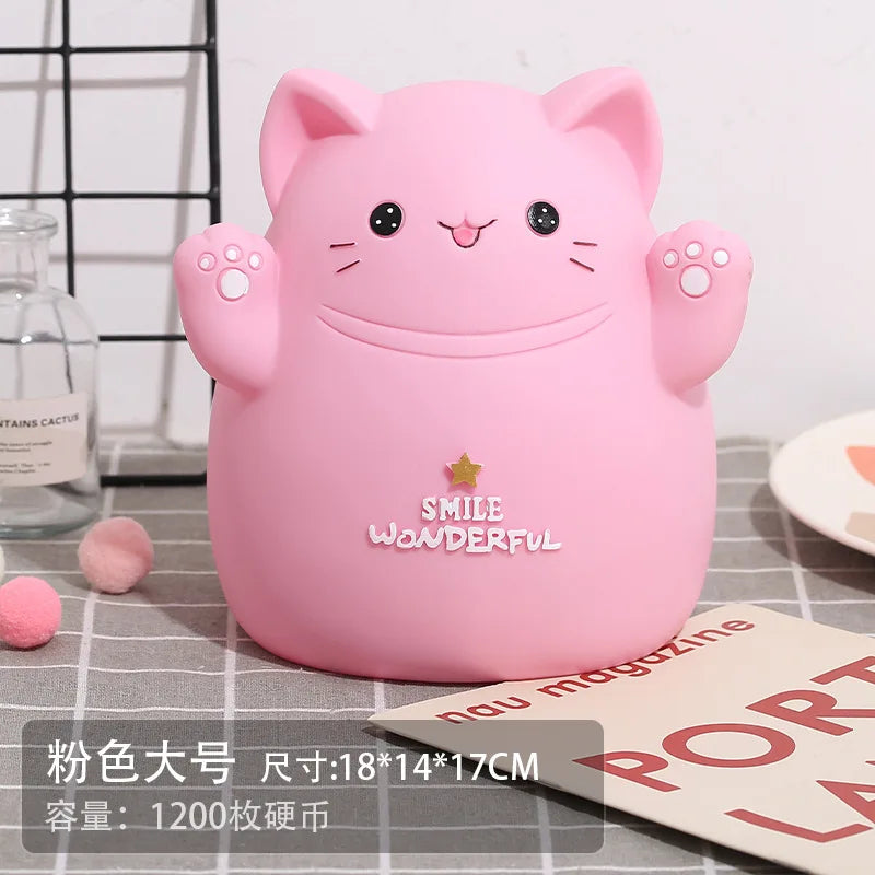 A pink cartoon cat piggy bank with smiling features resting on a gray checkered surface.