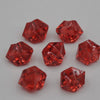 A collection of faceted, reddish-orange acrylic crystal decorations for parties.