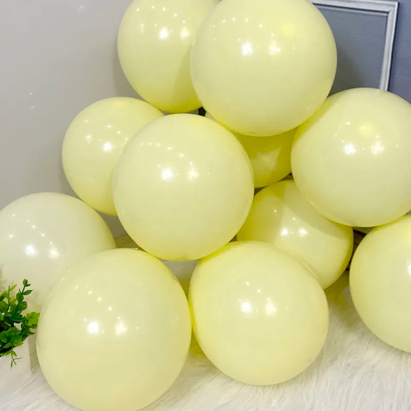 A cluster of pale yellow pastel candy balloons used for party decorations.