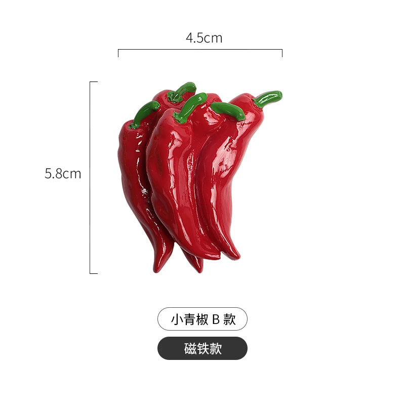 A set of realistic, bright red chili pepper fridge magnets with green tops.