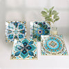 A collection of five blue and teal mandala tile stickers displayed on a white background with a green plant in the background