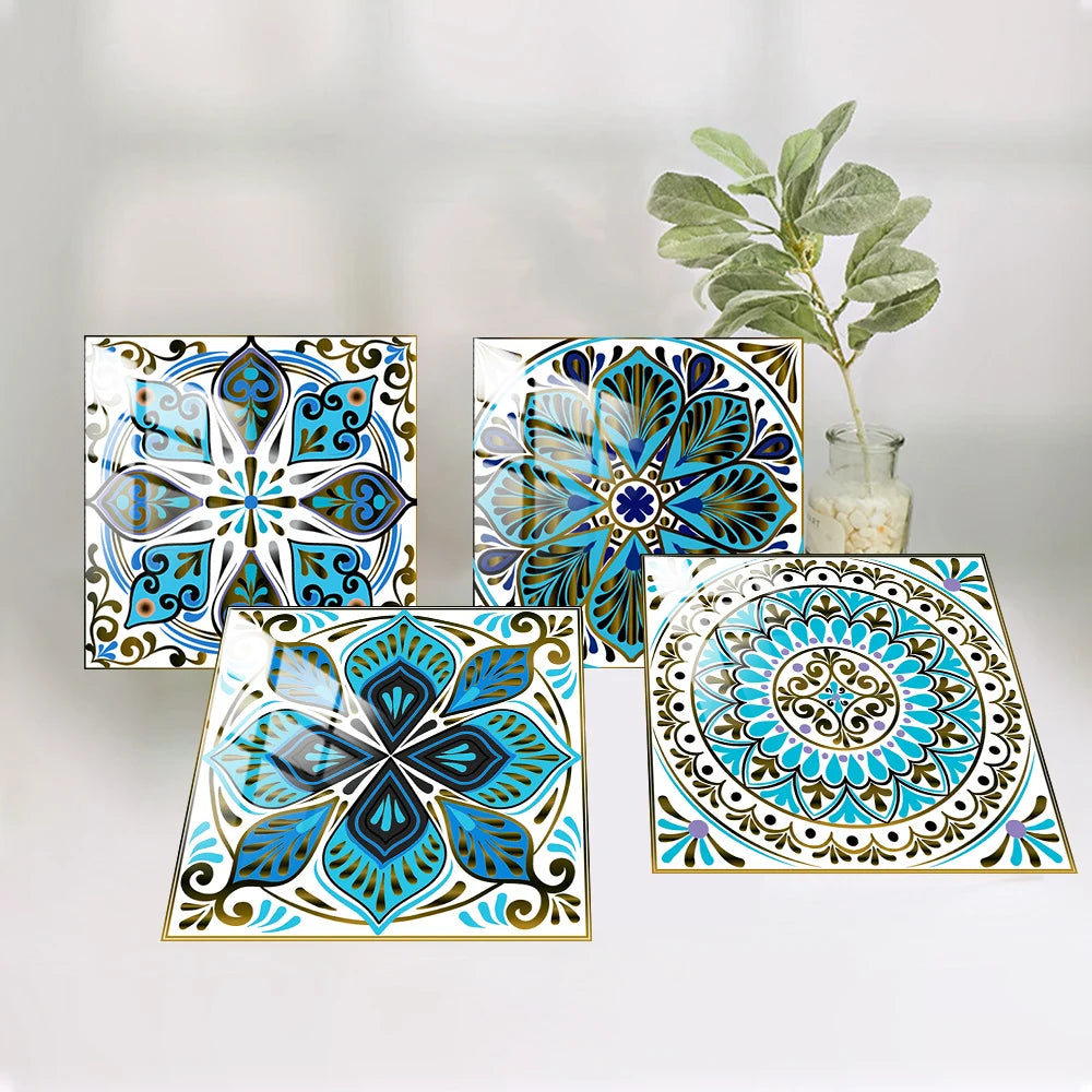 A collection of five blue and teal mandala tile stickers displayed on a white background with a green plant in the background