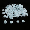 A pile of assorted white snap buttons, measuring 12mm and 10.5mm, scattered on a black surface.